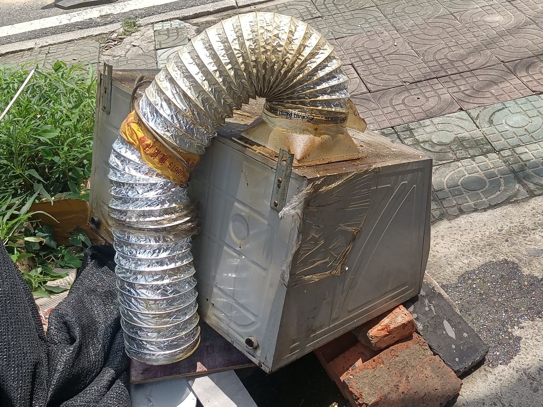 A foil flexible duct taped to a metal box